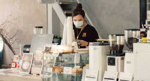 Person taking money from an ATM machine.