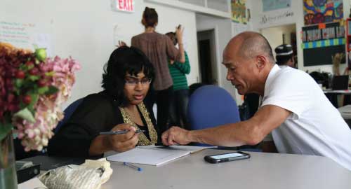 People looking at a sheet of paper.